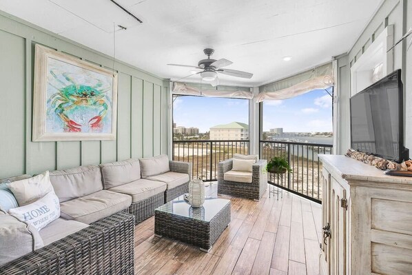 Spacious, stylish, tranquil balcony with comfy seating, TV, and bay view.