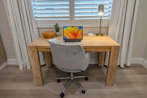 This well-equipped Crate & Barrel desk features a comfortable rolling chair and a built-in charging station, making it ideal for productive work sessions. Enjoy a dedicated workspace that enhances your productivity!