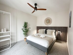 Bedroom full of light with ceiling fan
