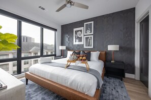 Primary Bedroom with King bed, smart TV, walk-in closet, and en-suite bathroom.