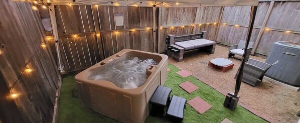 Your backyard escape: a spa that adapts to your desires, set under a gazebo's shelter, with the allure of glowing strip lights.