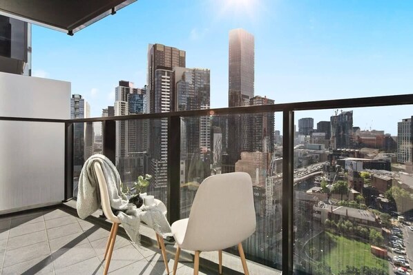 Enjoy city views from the balcony *(Chairs on balcony are from the from the dining area).