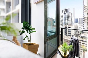 A balcony with city views. *(Chair on balcony is from the dining area)