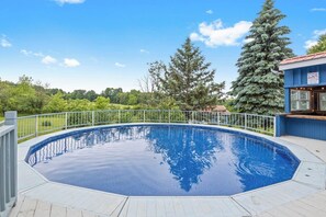 Relax in the spacious above-ground pool, perfect for cooling off on warm days.