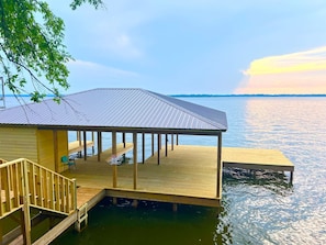 private boat dock with available stall by request or lift rental if available and boat specs. Huge open sun deck for catching rays, fishing or star gazing!