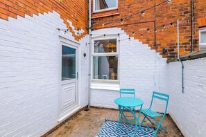 The outdoor area benefits from a patio and a place to sit down and relax.