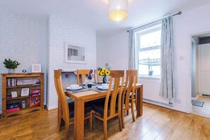 The spacious dining room has space to seat up to 6 people comfortably and is the perfect space to sit down with family and friends for an evening meal or catch up on emails if you are working remotely.