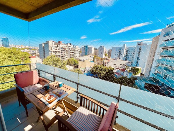Pet-safe balcony overlooking the tree-lined cobblestone road. 7th floor