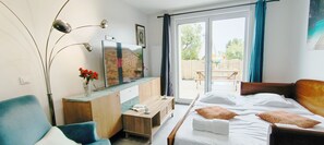 Living room with a sofa bed and tv.
