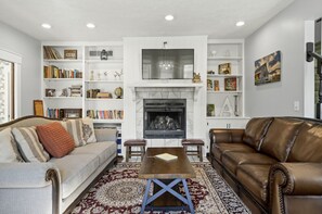 Living room with gas fireplace and cozy seating.