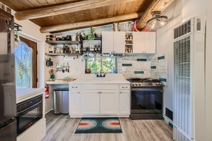 Fully equipped kitchen, stocked with many staples.