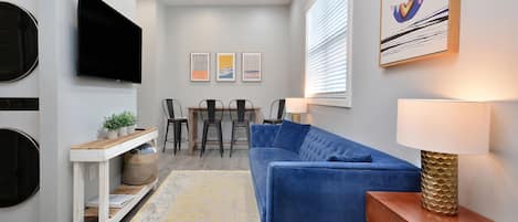 Living space: 55" TV, couch, side tables, bar table