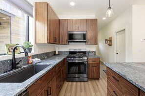 The kitchen is equipped with a dishwasher and offers ski slope views from the sink.