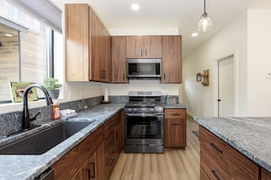 The kitchen is equipped with a dishwasher and offers ski slope views from the sink.