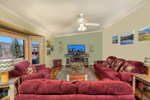 Get cozy with our comfy couches with a 65" Roku set up TV and electric fireplace