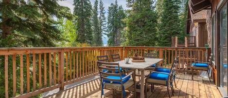 Huge back deck with dining table, chairs, lounge chairs, BBQ and amazing lake view!