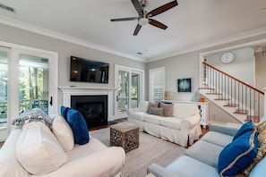 The living area has a 65" Smart TV.  The fireplace is decorative only. Double doors lead out to the screen porch