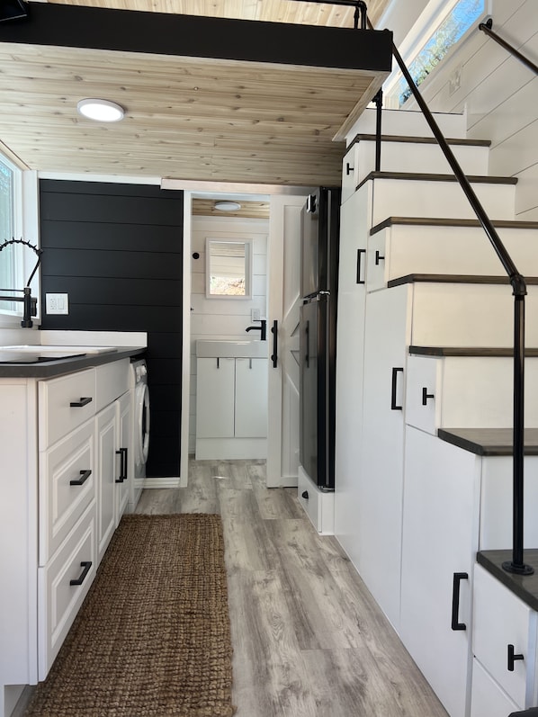 Kitchen with stairway storage and bathroom