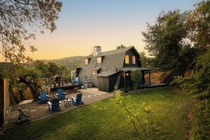 Side and front yard with string lights lit up and the golden sunsets