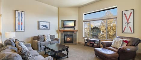 Sun Filled Living Room - Comfortable Sofas and Chair, Large TV & Gas Fireplace