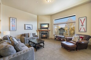 Sun Filled Living Room - Comfortable Sofas and Chair, Large TV & Gas Fireplace