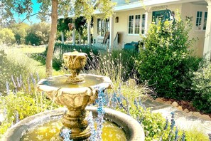 Vibrant seasonal blooms adorn the lush landscaping and gardens year-round.