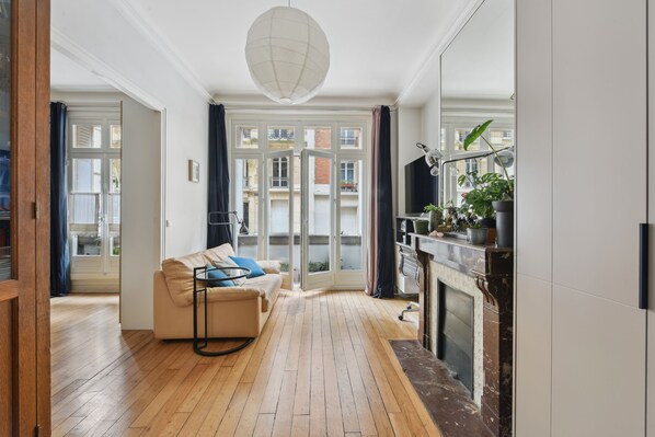 The apartment's hall opens on a large lounge area with south facing windows