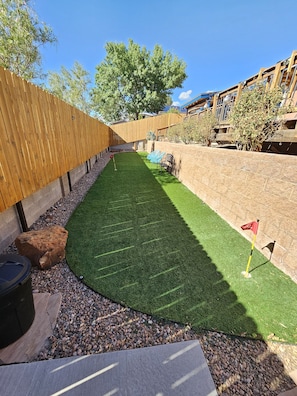 Fully fenced in turf yard for your 4-legged friends. Put put and yard games!