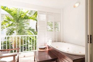 The balcony is fitted with a jetted spa tub to enjoy a warm or cold soak in leafy seclusion. 