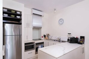 The kitchen comes well-equipped to prepare meals at home, or you may reserve your seats at the onsite restaurant. 