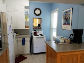 Complete kitchen with small appliances and basic cooking items supplied.