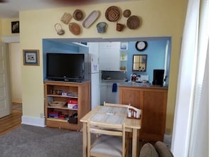 View from Living room to Kitchen. Notice 49" HDR TV with built in Chromecast