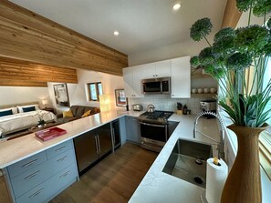 Galley Kitchen with Quartz Countertops. 