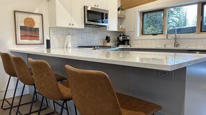 full-size Kitchen with all the appliances and essentials. Quartz Stone bar! 