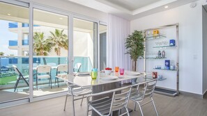 Colorful dining area with glass topped table.