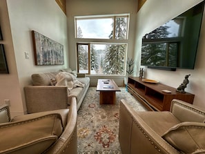 Sullivan House living room, large picture window to enjoy the forest view. 