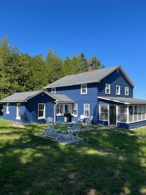 Side view of house showing screened porch and view of Lake.