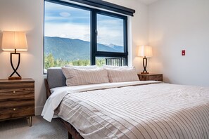 Expansive mountain views out the primary bedroom window