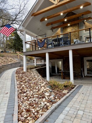 Two levels of outdoor seating with a covered roof.