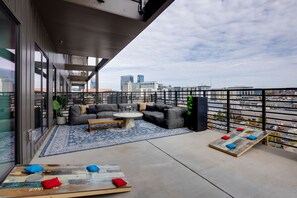 Main Level: Large private patio with a large lounge area, cornhole, giant Jenga, and additional seating overlooking the Nashville skyline.