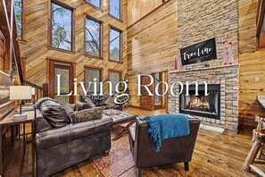 Enjoy our open concept living area, ideal for family gatherings, featuring plush seating and a cozy fireplace.