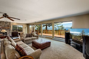 Relax in the spacious living room with floor-to-ceiling windows and stunning views