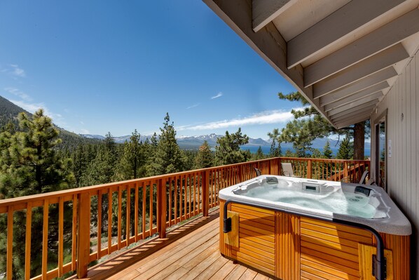 Soak in the private hot tub while taking in breathtaking mountain views
