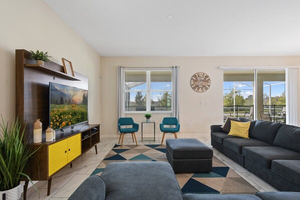 Stylish, bright living room with modern decor and relaxing outdoor views.