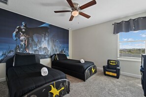 Fun superhero-themed bedroom perfect for kids, with twin beds and city views.