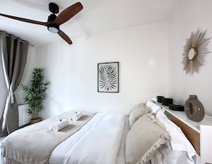 Bedroom full of light with ceiling fan