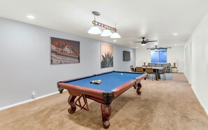 Basement Level: Recreational Room featuring a Pool table for friendly competition, 2nd living area with a Smart TV, and a long table perfect for card / board games.