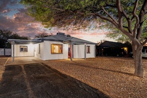 View of home's front entrance, carport, and front yard
