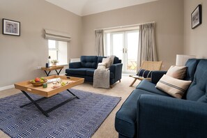 The Rushes - sitting room with doors leading out to the rear patio