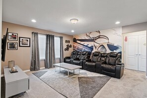 The ultimate relaxation spot with comfy recliners and a 65" Smart TV.